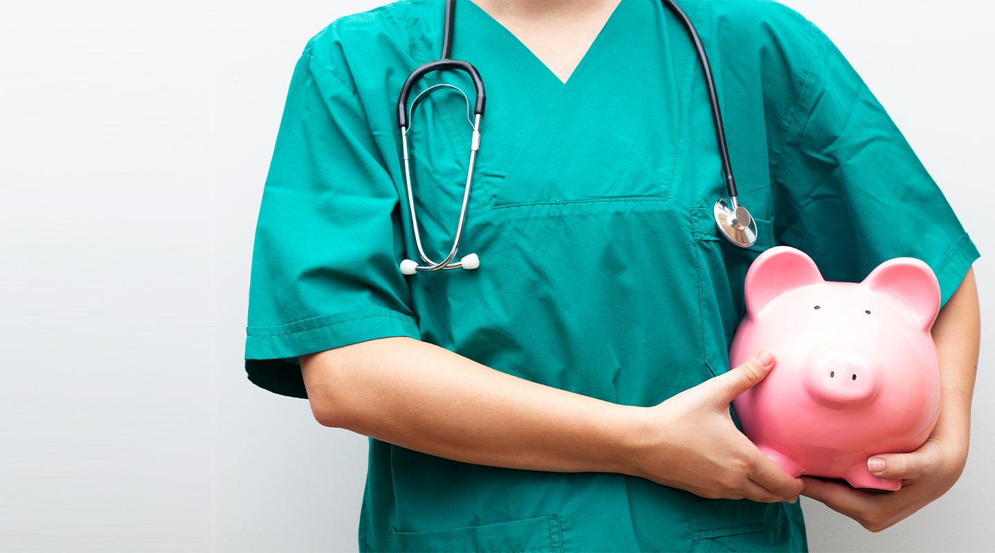 Doctor holding a piggy Bank
