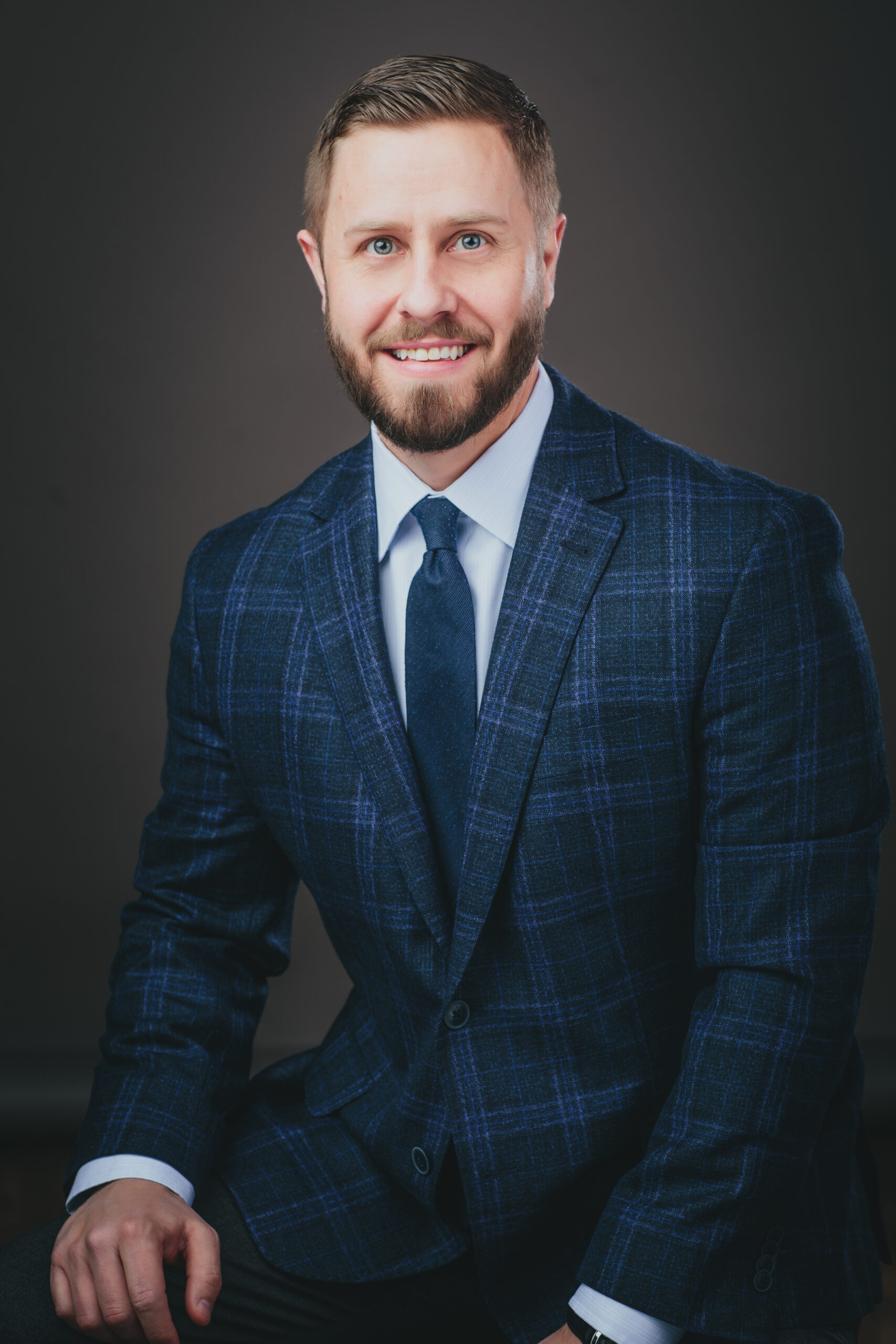 Jesse Hunt headshot, posing with suit and tie.