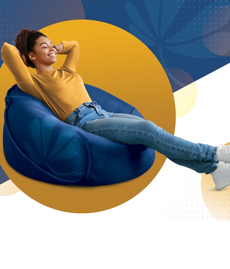 An image girl lounging in a bean bag chair happily, because that's how easy it is to use Click Switch to update your direct deposit.