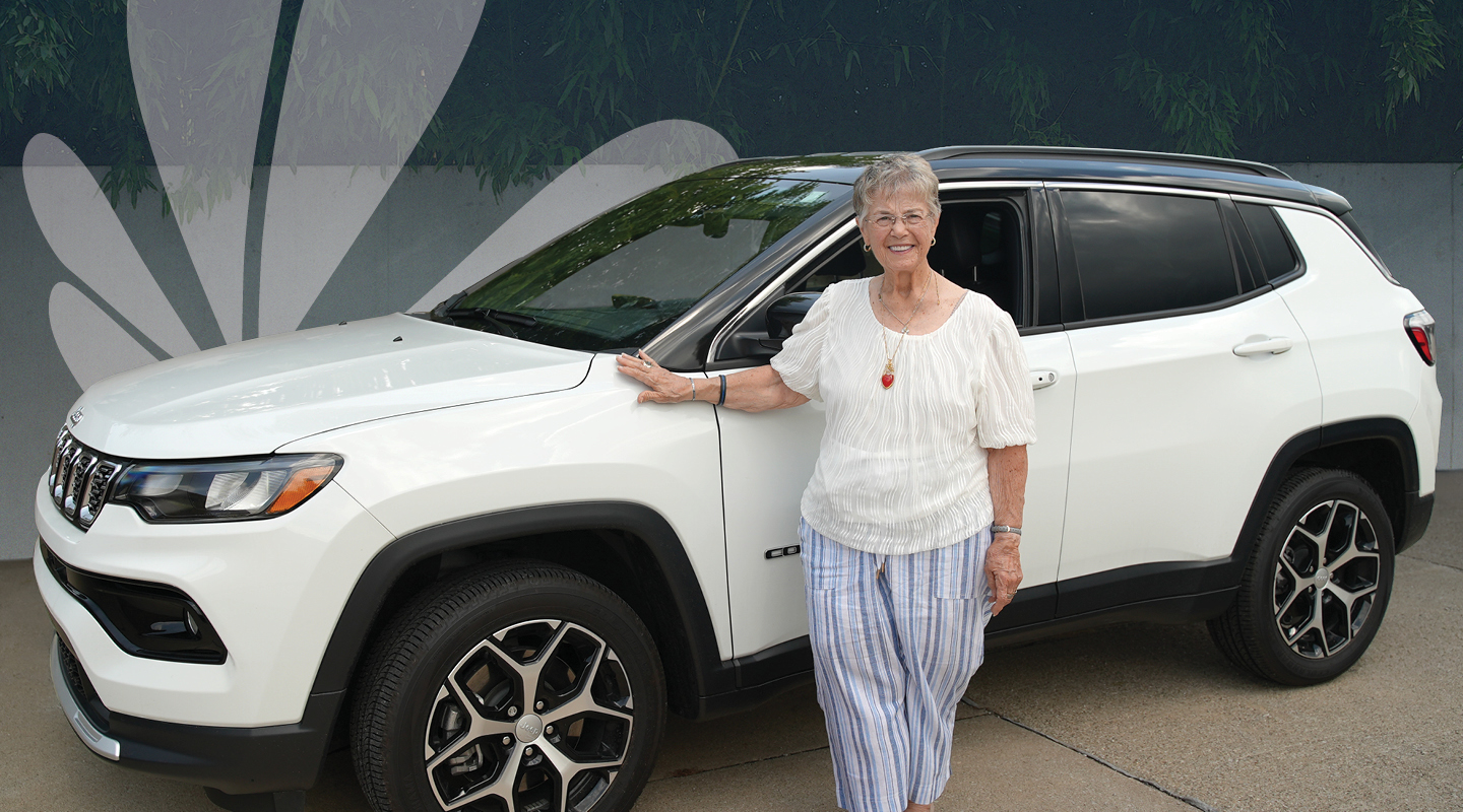 Woman standing next to her car financed by Notre Dame Federal Credit Union