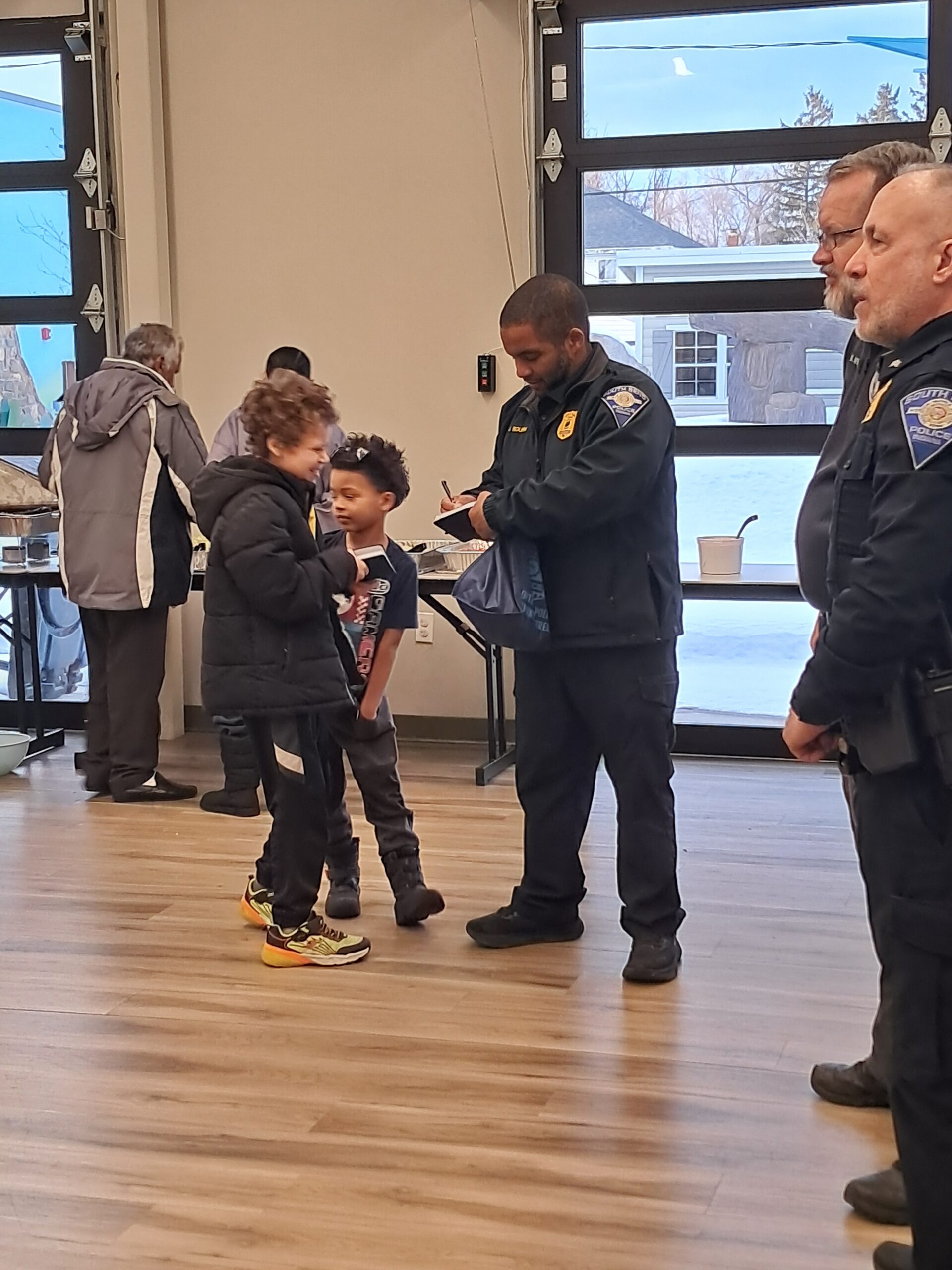 young boys asking SBPD officers for their signatures