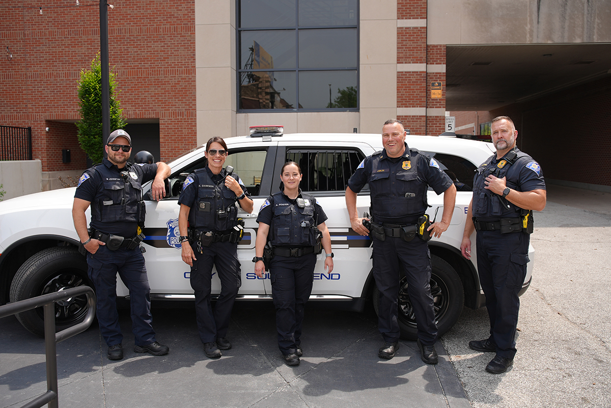 team of SPBD officers in front of police cruiser